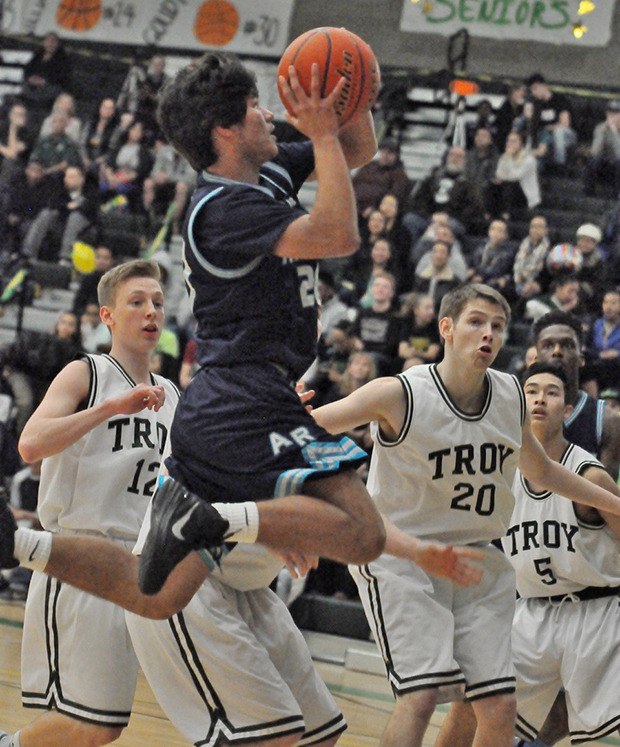 The Ravens' Austin Kirby drives for two against the Trojans' defense during SPSL 3A play Friday night.