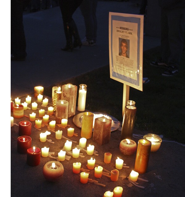 Candles surround a missing poster for Dwight Clark at Auburn's Brannan Skate Park on Saturday. More than a hundred friends and family turned out for a candlelight vigil for the missing Western Washington University freshman.