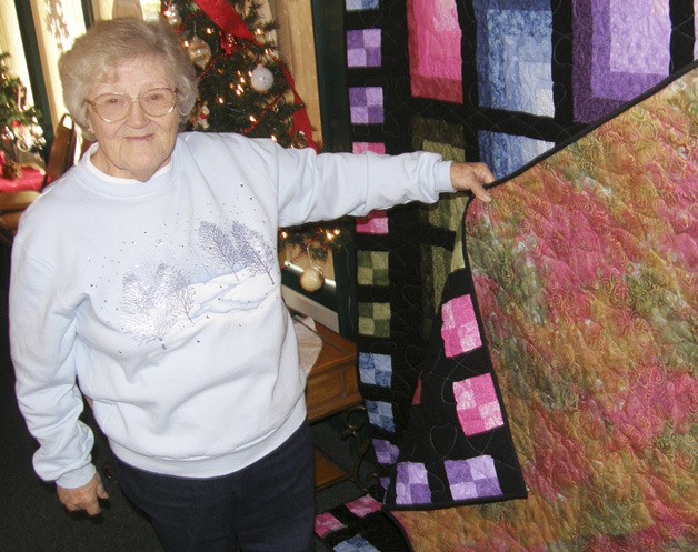 Peggy Ice of the River Crafters displays a quilt the group raffled off to raise funds for the Auburn Valley Humane Society.
