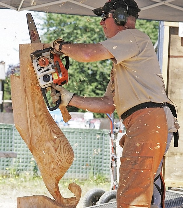 Auburn’s Jimbo Heldt carves a seahorse during the White River Chainsaw Carving Championship.