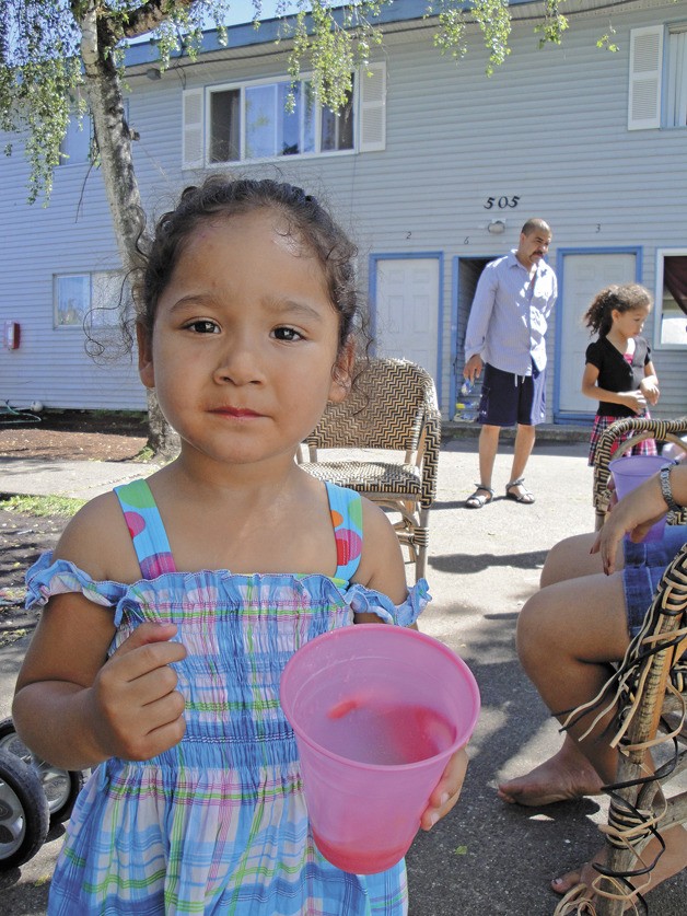 A child pauses during play in the Auburn Pines Apartments courtyard