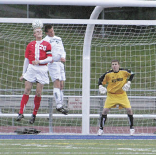 Jefferson’s DJ DeWaele goes up for a header with Kentwood’s Matt Eronemo as Conquerors goalkeeper Mitch Pombrio eyes the action. Kentwood won