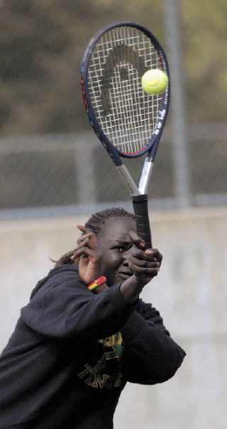 Auburn’s Nyareu Thong aims at a forehand shot during Monday’s No. 1 doubles match with partner Juliann Conklin as the Trojans wrapped up the SPSL 3A title.