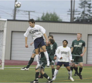 Auburn Riverside’s Max Thomas soars to head the ball toward the goal on a long throw-in. But Thomas’ attempt flew over the top. The Ravens fell behind 1-0