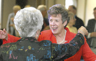 Linda Cowan greets Myrna Warwick at her retirement party as outgoing Auburn School District superintendent. Warwick