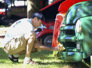 Scott Harvey treats the bumper of his 1954 Chevrolet truck during the sixth annual Cruise to the Park on Saturday. The benefit classic car show at Les Gove Park was put on by the Solid Rock Cruisers. Harvey has been restoring the truck for more than 10 years.  Gary Kissel/Reporter