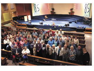 Senior members of the Northwest Family Church gather at the sanctuary that was built in 1965. The church celebrates its 85th anniversary this weekend.