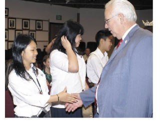 Auburn Mayor Pete Lewis shakes hands this week with exchange student Waka Ikeda