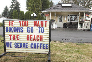 A sign in front of Auburn Java Junction on A Street Southeast and 7th Street Southeast offers a retort to the scantily-clad baristas who work at the Cowgirls Espresso just a few blocks away.