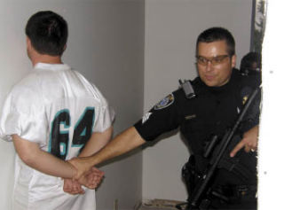 Algona Police Sgt. Lee Gaskill ascertains a mock suspect during a building search drill