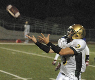 Auburn”s Austen Embody catches a pass before turning up field for a good gain in the first half against the Royals.