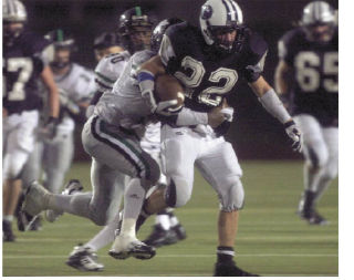 Auburn Riverside running back Corey Carson tries to escape the Kentwood defense