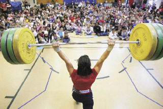 Olympic weightlifter Melanie Roach of Bonney Lake hoists 187 pounds in the clean-and-jerk lift in front of an all-school assembly Friday at Washington Elementary School. In the Beijing Olympics