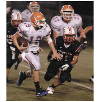 Auburn Mountainview junior quarterback Cody McNeil scampers for some yardage against the Cardinal defense. McNeil led the Lions with 149 yards rushing and two touchdowns.