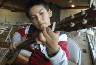 Hugo Sanchez practices on the guitar during lessons given by Leobardo Mota in the Jubilee Center at Auburn’s San Mateo Episcopal Church.