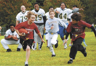 A.J. Sachs runs from pursuers during Auburn Flag Football League play held during the skills clinic by the Auburn High varsity football team.