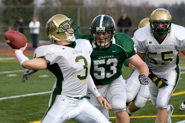 Auburn's Austen Embody attempts a pass on a trick play as Skyline's Rob Tramonte closes in. Skyline eliminated Auburn