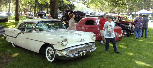 Classsic cars of all types line up at a past Solid Rock Cruisers Cruise-In annual car show at Les Gove Park. In the foreground is a 1957 Oldsmobile Super 88.