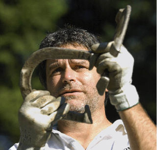 Auburn’s Don Davis practices his marksmanship daily as a state champion horseshoe pitcher.