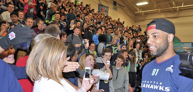 The Seahawks' Golden Tate greets students and staff at an assembly at Auburn Riverside High School on Thursday. Tate appeared on behalf of the Verizon Wireless Save It Seattle campaign