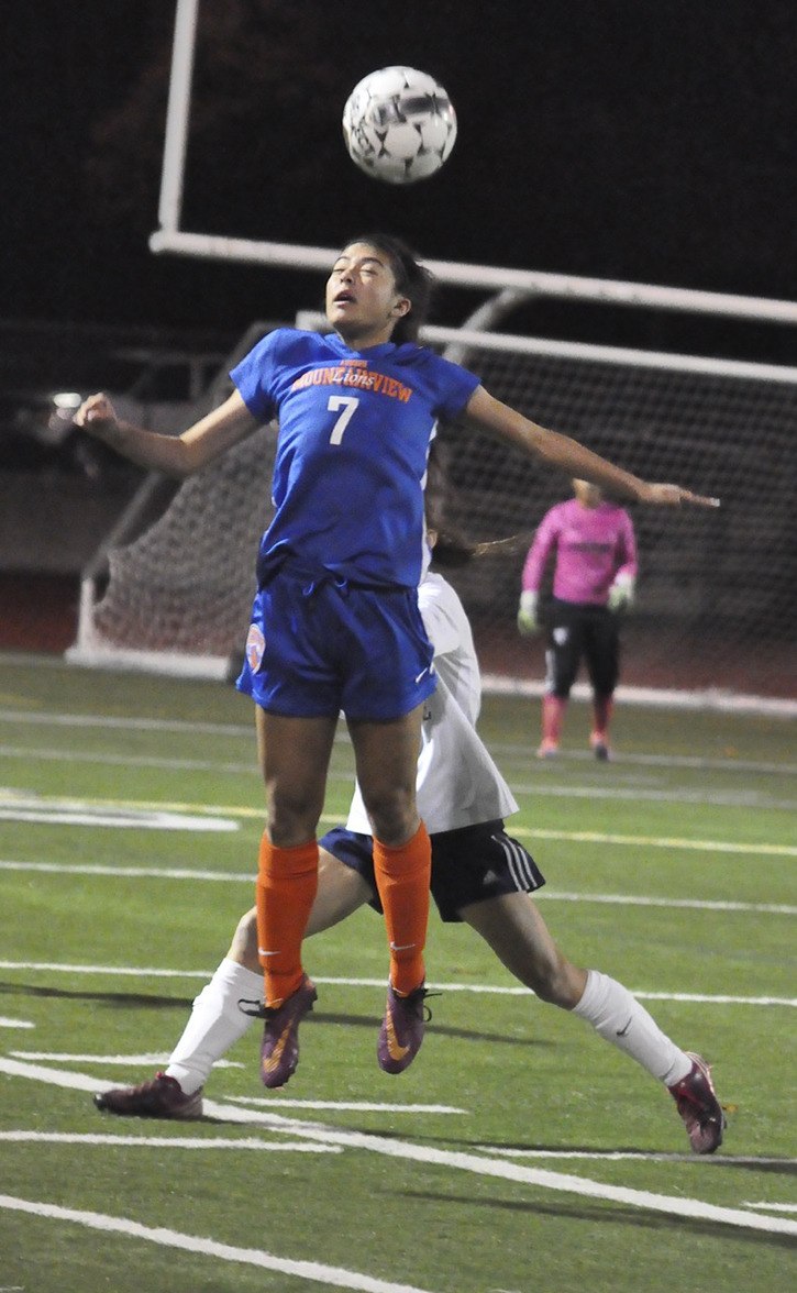 Auburn’s Mountainview’s Chloe Baquian heads a ball during the Lions’ 1-0 win Tuesday night in a South Puget Sound League 3A girls soccer match at Auburn Riverside.