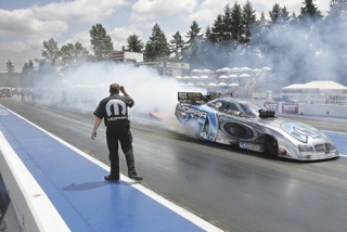 Gary Scelzi burns his tires in the Mopar Funny Car before a qualifying race Saturday at Pacific Raceways.