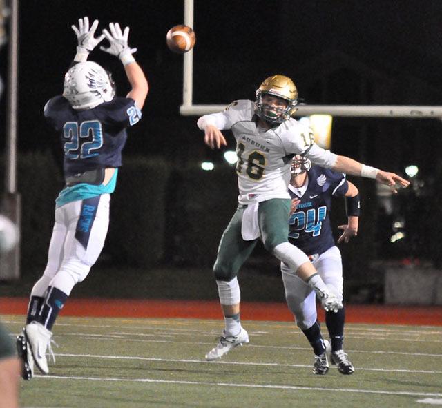 Auburn Riverside's Alex Caldwell attempts to block a throw from Auburn quarterback Zach Redelf during NPSL play Friday night.