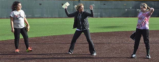 New Auburn coach Brenna Nesper works with her players in preparation for the Trojans’ home opener at 4 p.m. Tuesday against Holy Names Academy.