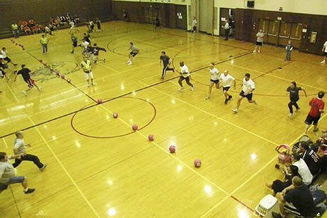 Let the games begin: Teams scramble to seize dodgeballs during a recent fundraising tournament at the Auburn High School gym. The event