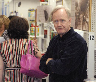 Pat Cavanaugh stands among the crowd of customers on his last day of business.