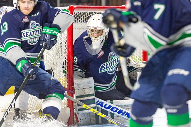 With Mathew Barzel (13) defending, Thunderbirds goalie Matt Berlin anticipates a shot during WHL play against Victoria on Saturday night. COURTESY PHOTO, Brian Liesse, T-Birds