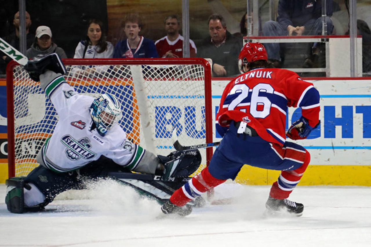 Thunderbirds goalie Rylan Toth slides to make a save on a shot by the Chiefs’ Hudson Elynuik during WHL play Tuesday night. COURTESY PHOTO