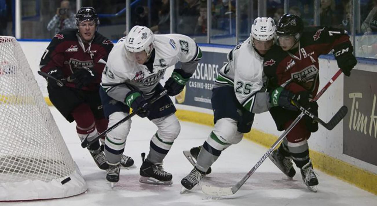 The Thunderbirds’ Mathew Barzel, left, and Ethan Bear battle the Giants behind the net during WHL play Saturday night in Vancouver, B.C. COURTESY PHOTO