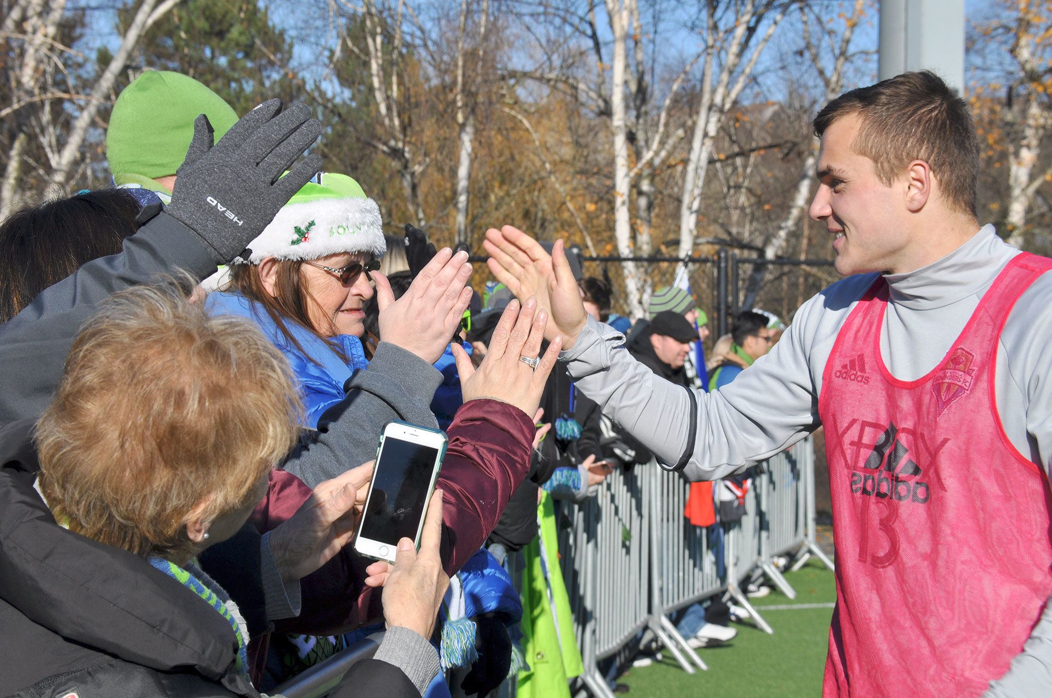 Seattle Sounders forward Jordan Morris high-fives fans during a send-off celebration for the MLS Cup-bound Sounders. HEIDI SANDERS/Tukwila Reporter