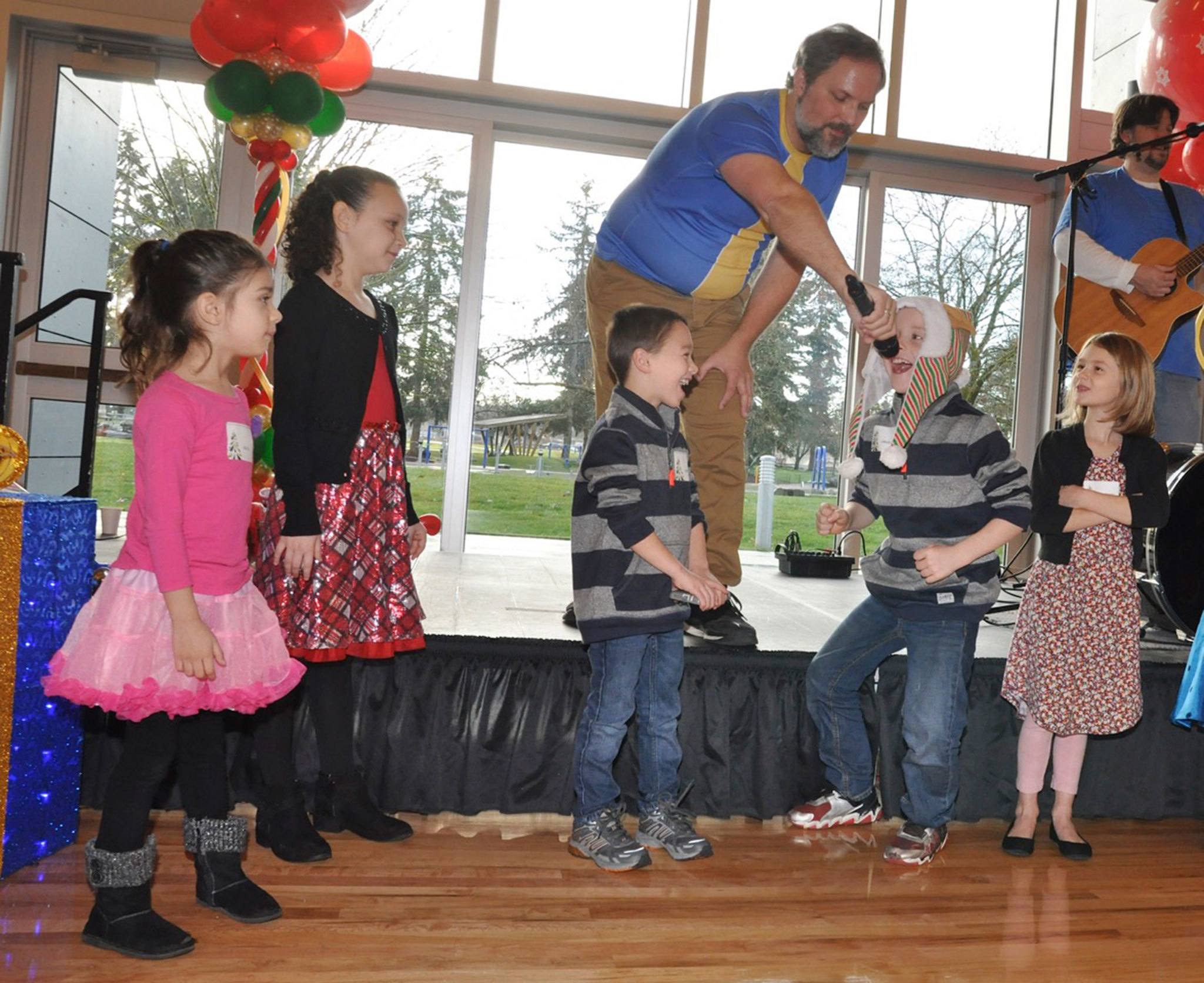 Eric Herman shares the mic with Jakob Astrup, 7, to sing a part of his band’s song, with Puppydog Dave on the guitar. The music was part of the Santa Breakfast at the Auburn Community and Events Center last Saturday. Auburn Parks, Arts & Rec hosted the breakfast, served up by Santa’s elves, with entertainment and a special visit from Santa. RACHEL CIAMPI, Auburn Reporter