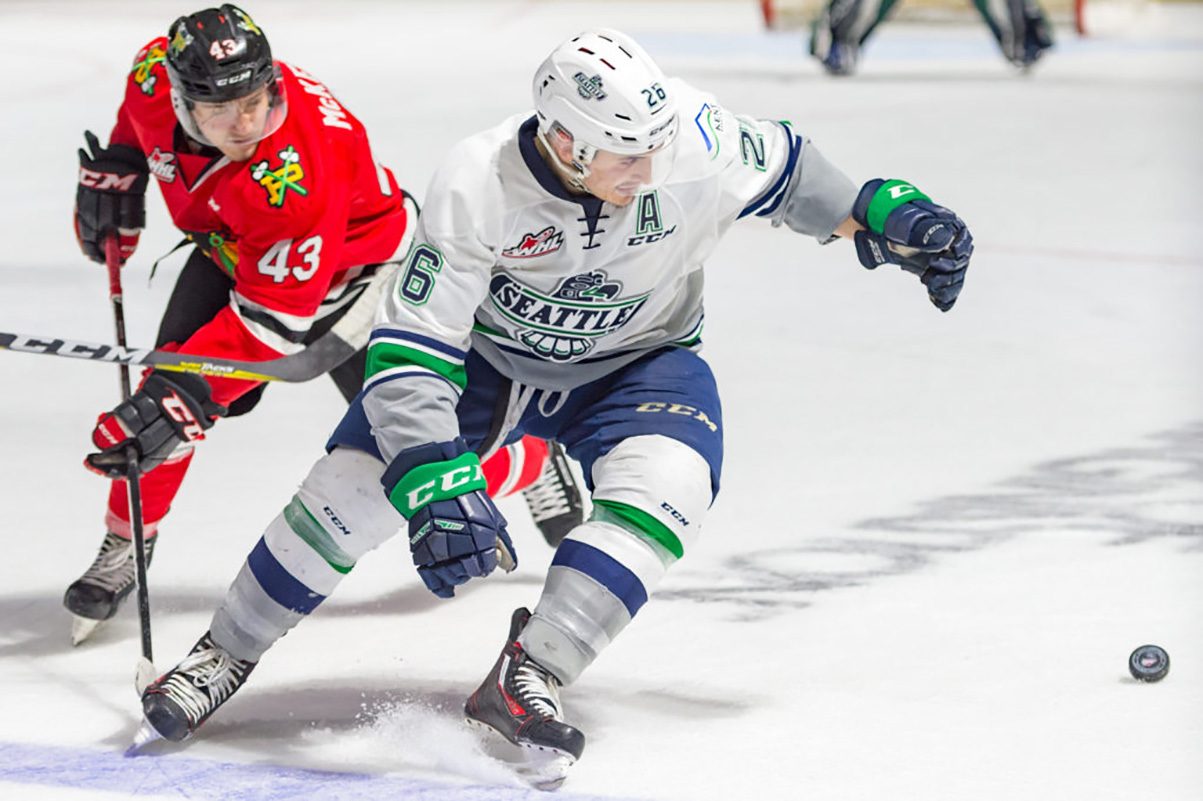 The Thunderbirds’ stickless Nolan Volcan and the Winterhawks’ Skyler McKenzie scramble for the loose puck during WHL action Friday night at the ShoWare Center. COURTESY PHOTO, Brian Liesse/T-Birds