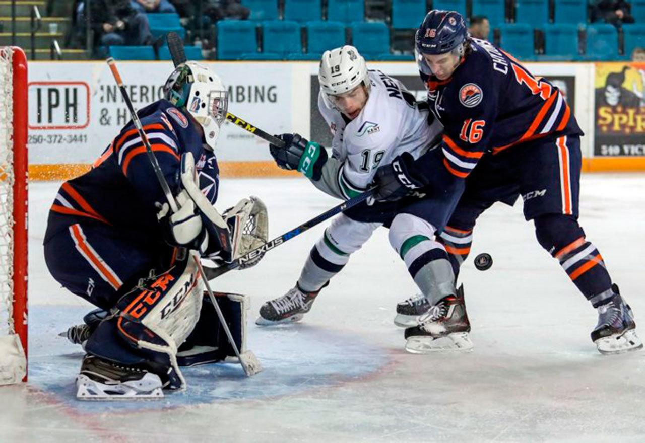 The Thunderbirds’ Donovan Neuls battles the Blazers’ Nick Chyzowski for the puck in front of Kamloops goalie Connor Ingram during WHL play Wednesday night. COURTESY PHOTO, Allen Douglas