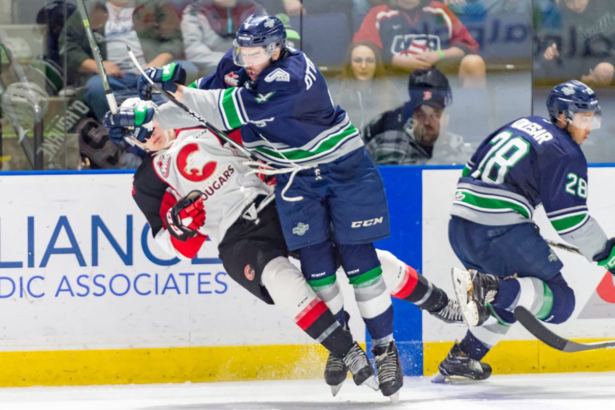 Thunderbirds defenseman Turner Ottenbreit delivers a hard check on a Prince George play during WHL play Friday night. COURTESY PHOTO, Brian Liesse, T-Birds