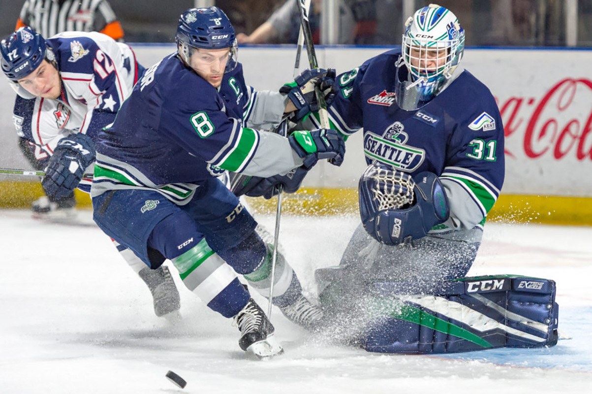 Thunderbirds captain Scott Eansor looks to clear the puck in front of goalie Rylan Toth during WHL play Saturday night at the ShoWare Center. COURTESY PHOTO, Brian Liesse/T-Birds