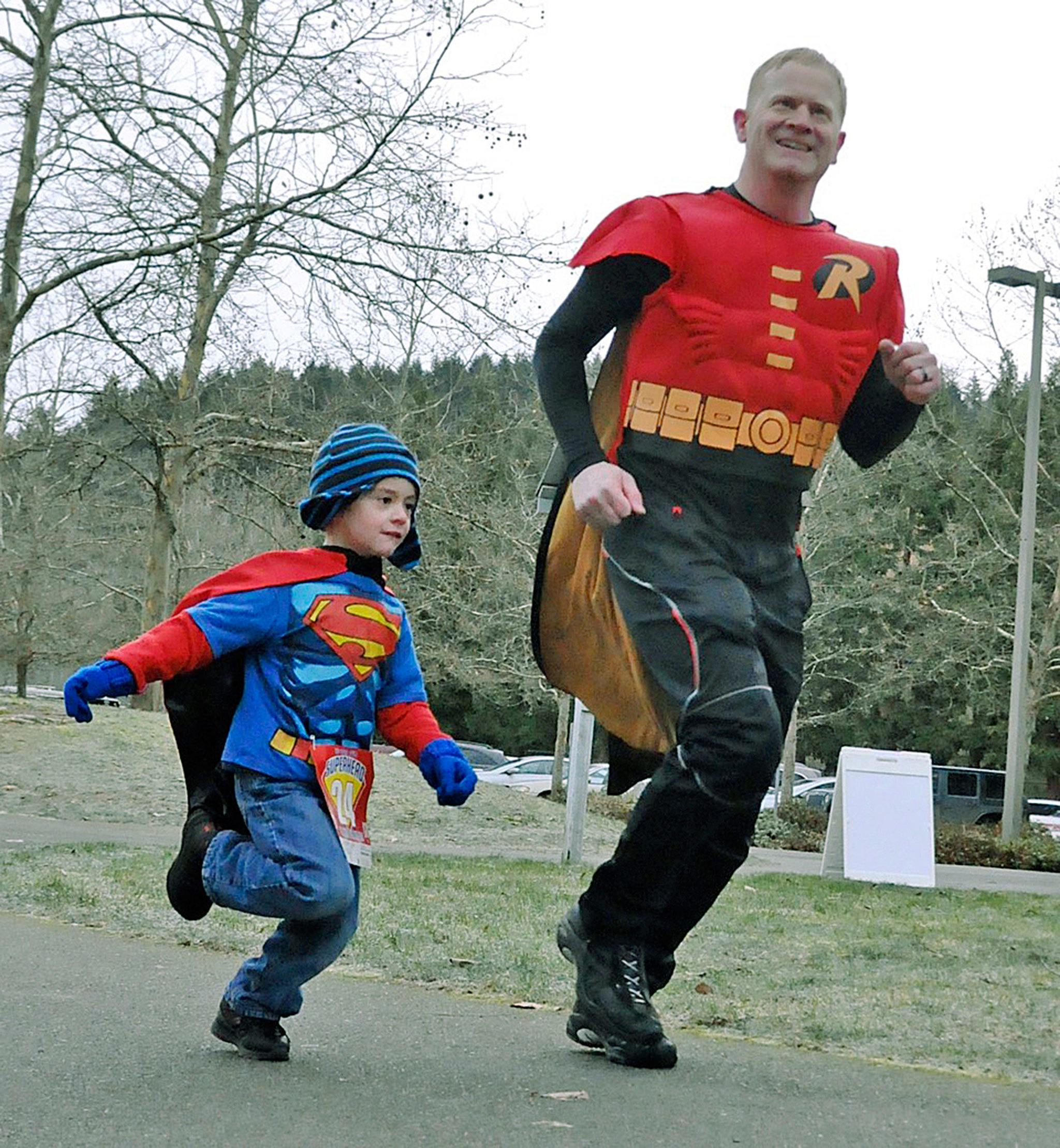 Jason Morreira as Robin with his son, Aiden, 4, as Superman, take off in The Be Your Own Superhero 5K and Kids’ 1K Fun Run at Roegner Park last Saturday. RACHEL CIAMPI