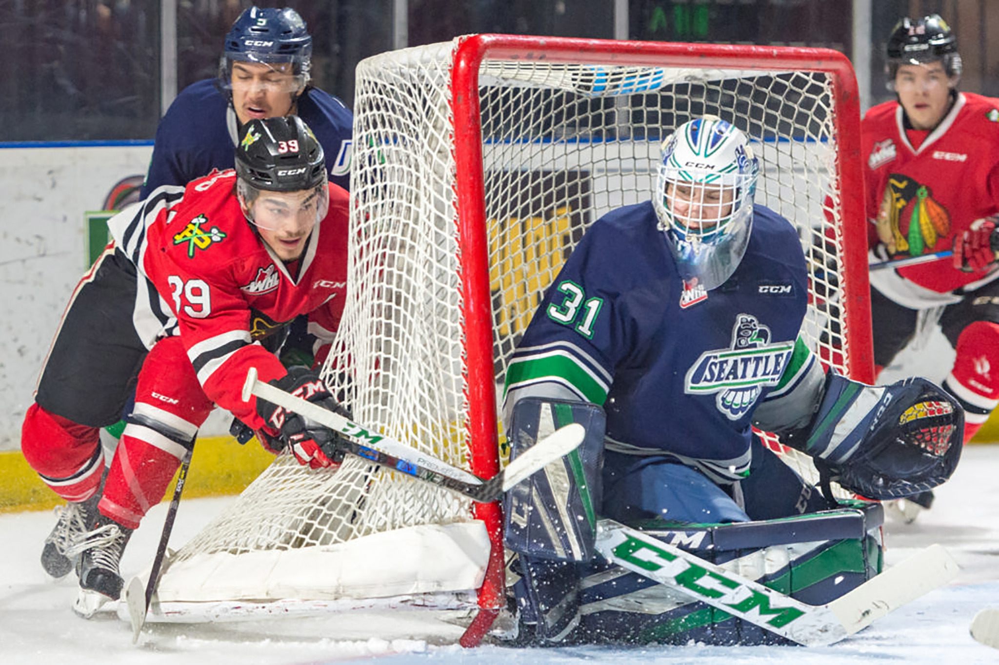 The Winterhawks’ Colton Veloso tries to wrap around a shot at the Thunderbirds’ Rylan Toth during WHL play Saturday night at the ShoWare Center. COURTESY PHOTO, Brian Liesse, T-Birds