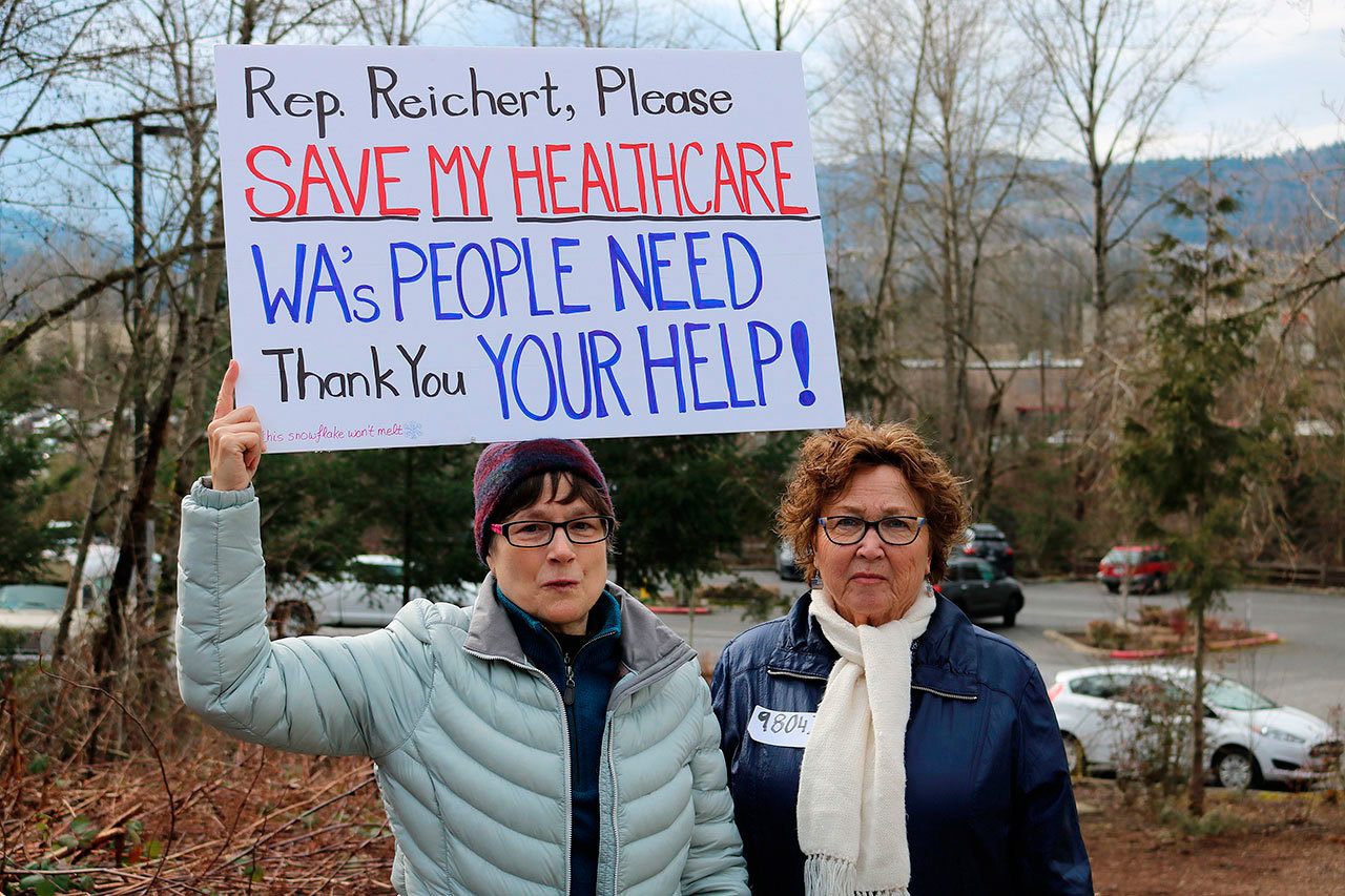 From left, Marion Kee of Redmond and Sharon Kay of Kent befriended one another at the rally after coming together to discuss their concerns for health care and immigration in the United States. Kee, who twice survived cancer, said that the Affordable Care Act has made it possible for her to have health care. Nicole Jennings, Issaquah Reporter