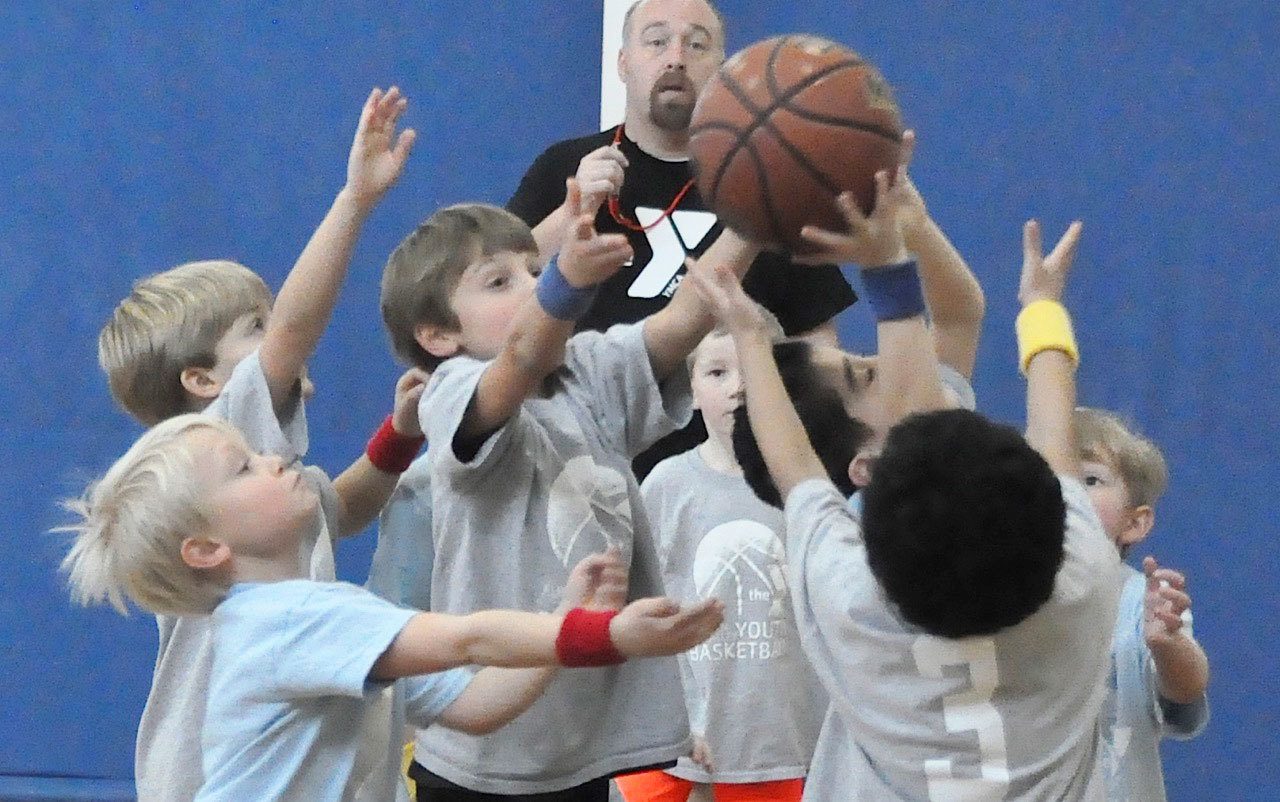 The Holy Family Catholic School Hawks basketball team battles the Blue Dragons for the rebound during play at the Auburn Valley YMCA gymnasium this past weekend. The school’s kindergarten, first-, second- and third-grade teams were in action. RACHEL CIAMPI, Auburn Reporter