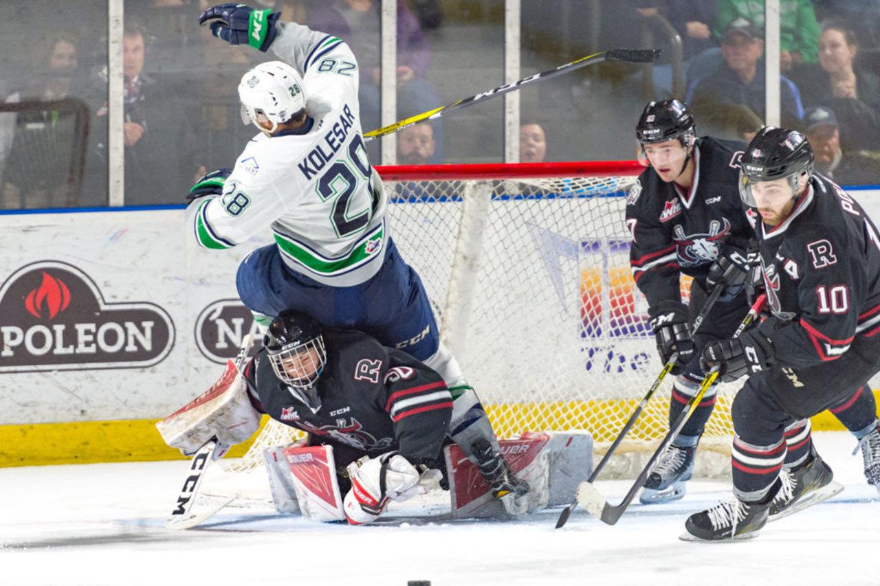 The Thunderbirds&rsquo; Keegan Kolesar tumbles over Rebels goalie Riley Lamb during WHL play Tuesday night. COURTESY PHOTO, Brian Liesse/T-Birds