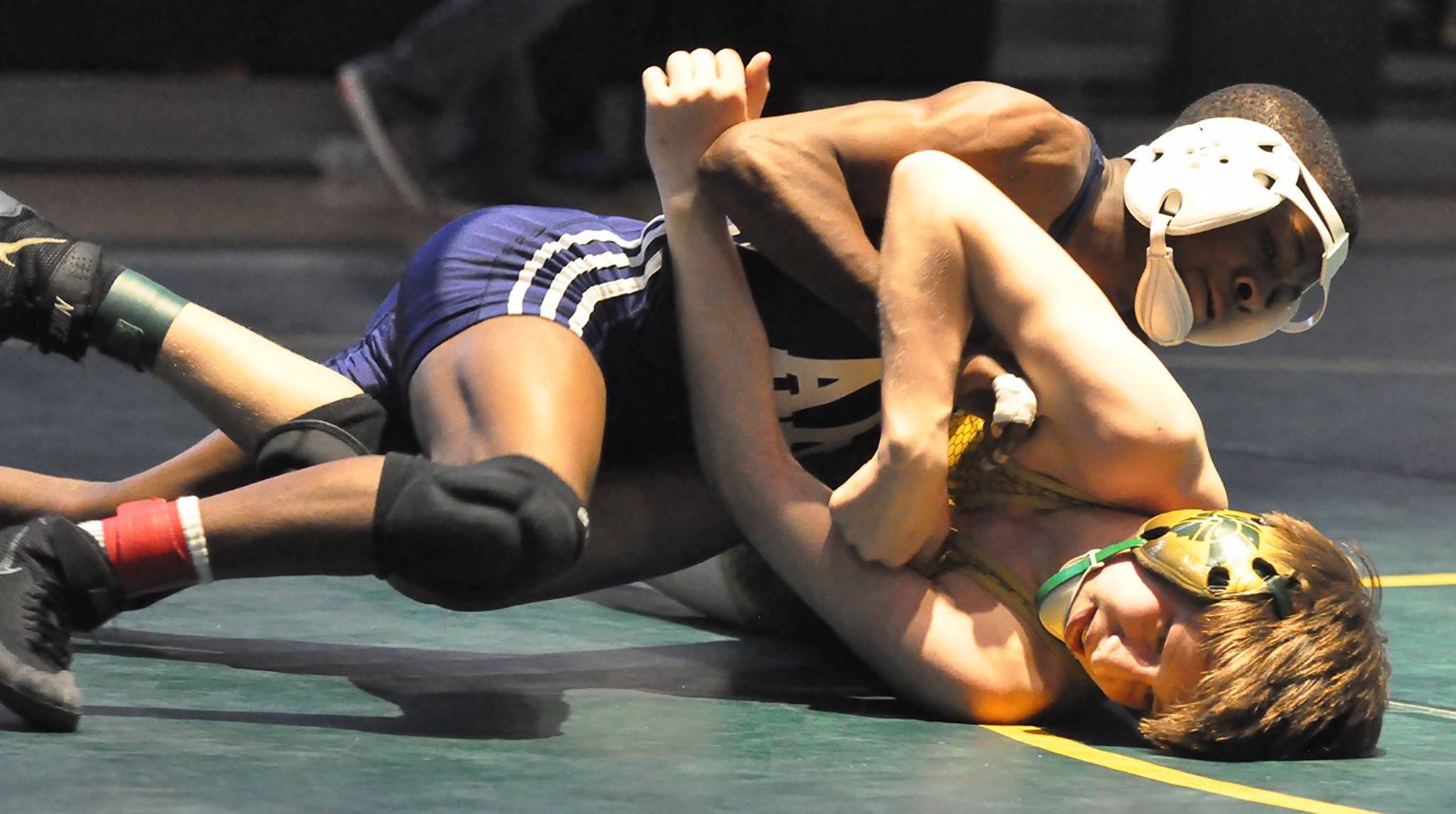 Auburn Riverside’s Yusef Nelson rides Auburn’s Jake Aplin during their 113-pound title bout at the sub-regional wrestling tournament at Auburn High School on Saturday. Nelson posted a 13-5 decision. RACHEL CIAMPI, Auburn Reporter