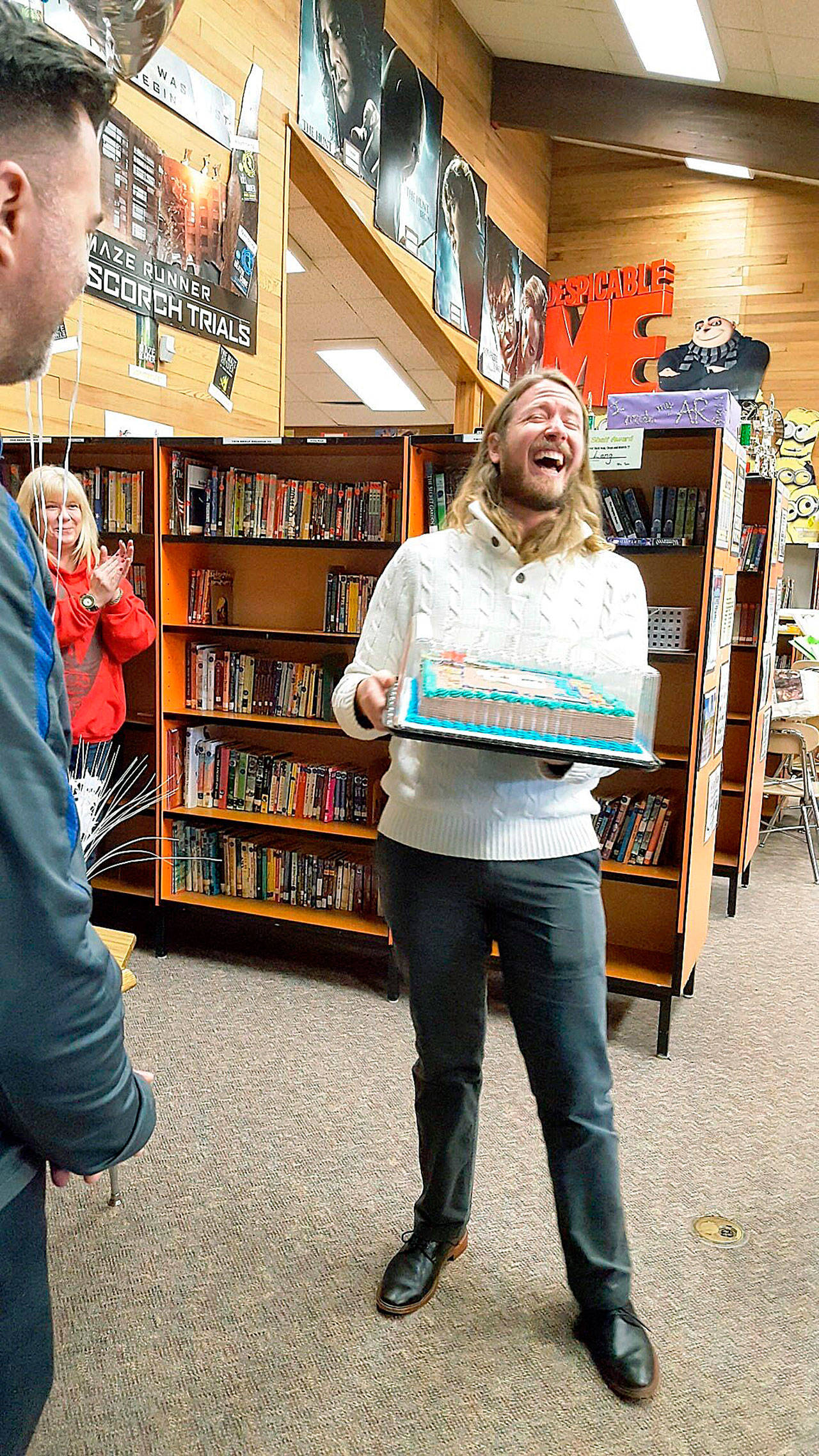 WGU Washington and Evergreen Heights staff surprised Richard Robertson on Monday with a cake, balloons and the news he had been chosen to receive a $10,000 scholarship from the Kent-based online university. COURTESY PHOTO, WGU Washington