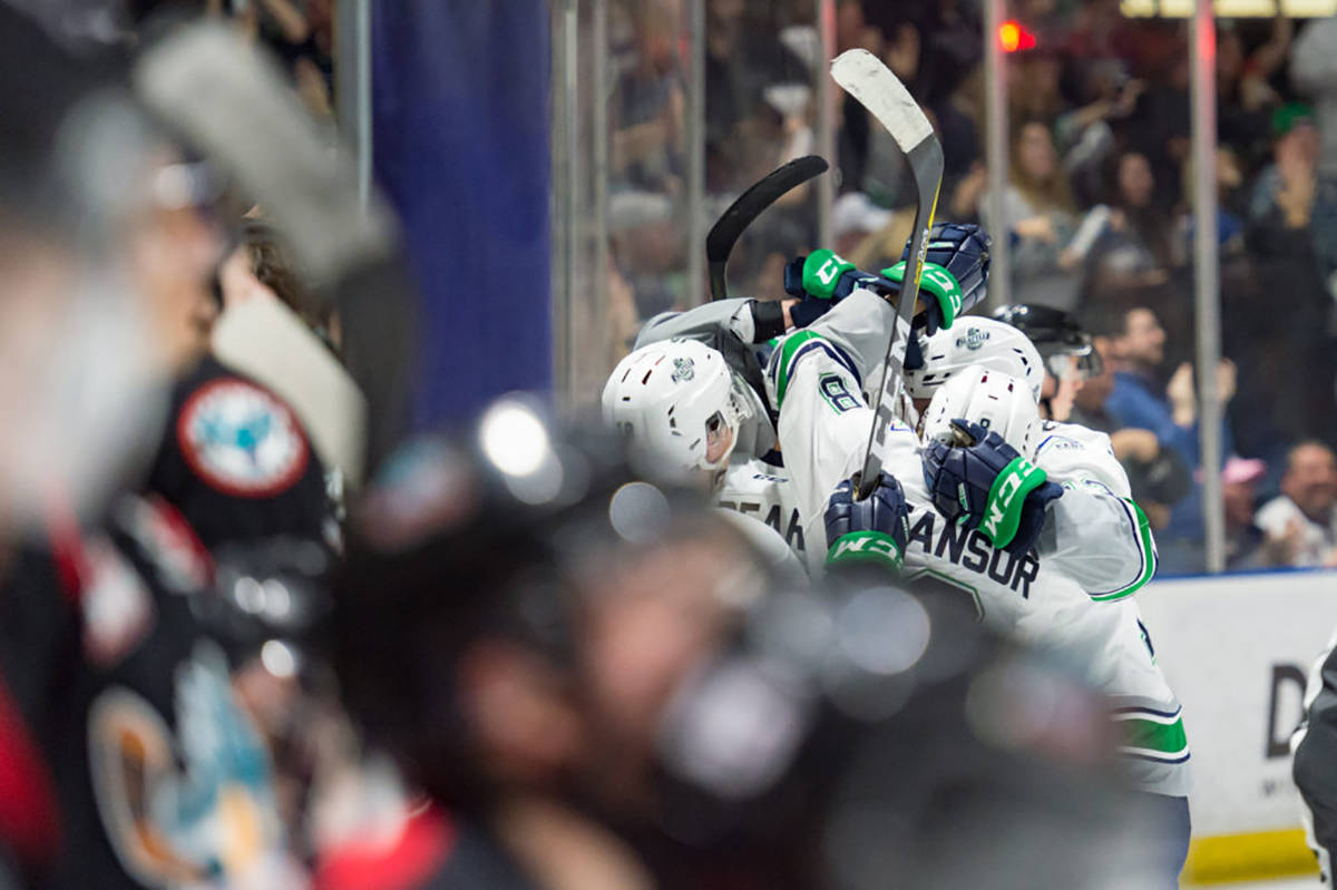 Teammates swarm Ethan Bear after the Thunderbirds defenseman scored a power-play goal with 12 seconds left to give Seattle a 5-4 win over the Kelowna Rockets in Game 1 of the WHL Western Conference championship series Friday night at the ShoWare Center. COURTESY PHOTO, Brian Liesse/T-Birds