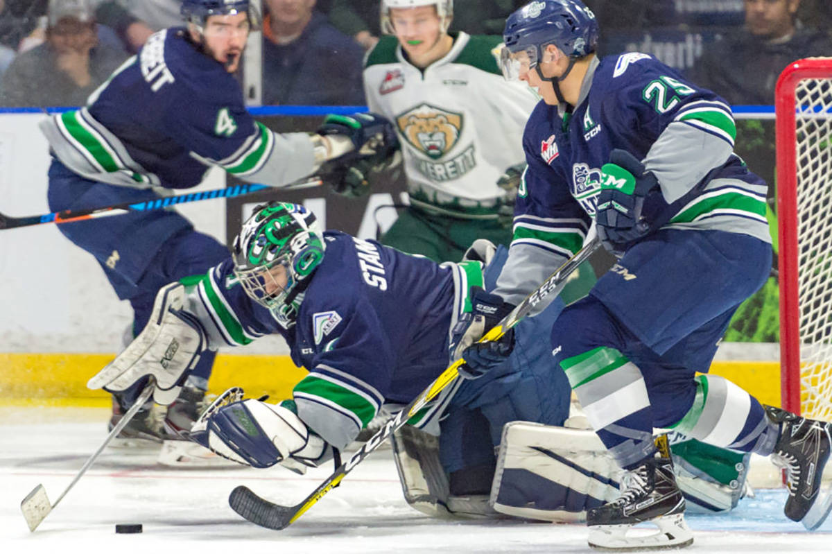 Seattle goalie Carl Stankowski covers the puck with trusty defenseman Ethan Bear next to him during WHL playoff action against the Silvertips on Saturday night in Everett. Stankowski made 20 saves on 23 shots to improve his playoff record to 6-0. COURTESY PHOTO, Brian Liesse, T-Birds