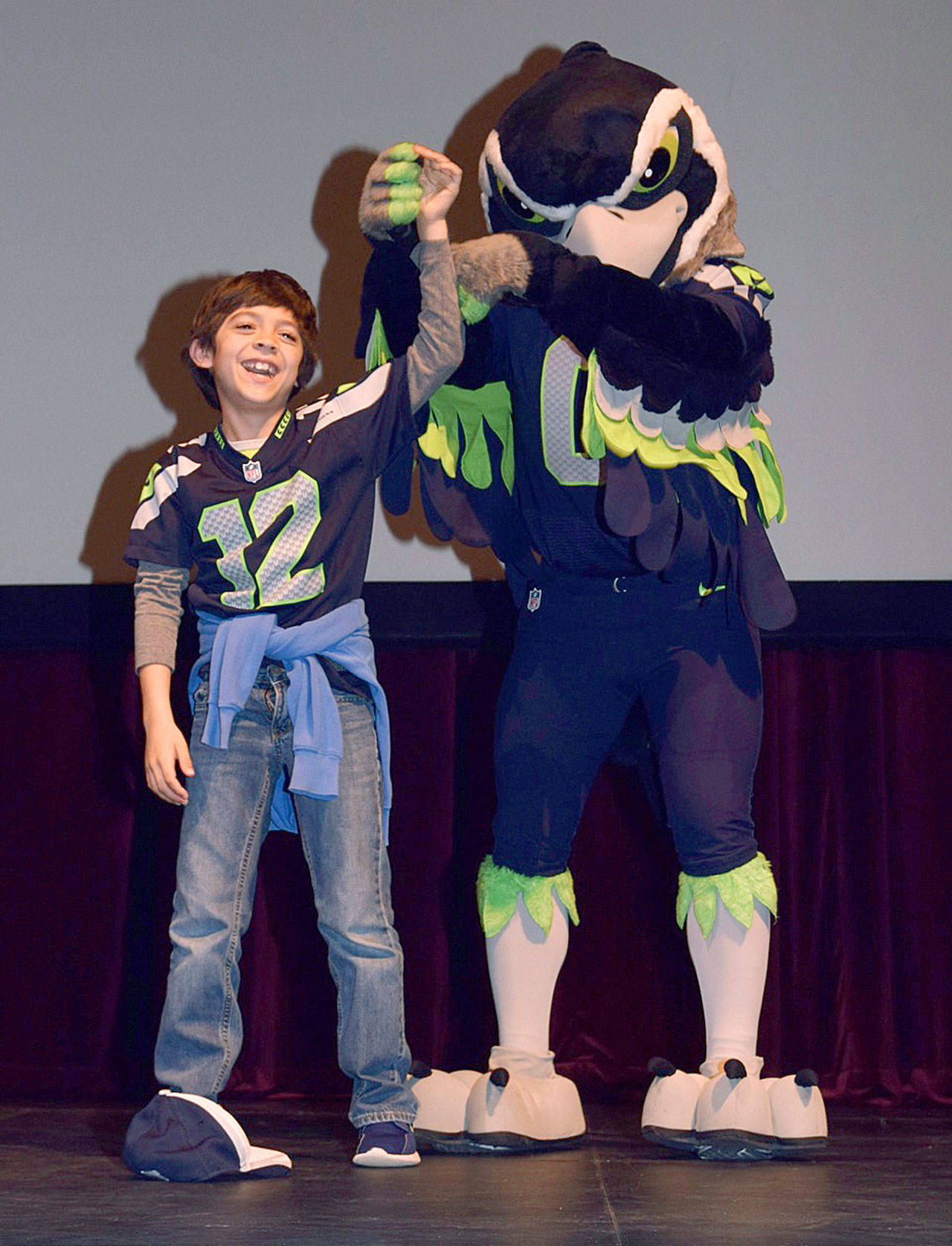 Blitz, the Seahawks’ mascot, performs with Landon Olguin, a third-grader at Pioneer Elementary School, during a Fuel Up to Play 60 rally Tuesday morning at the Performing Arts Center. RACHEL CIAMPI, Auburn Reporter