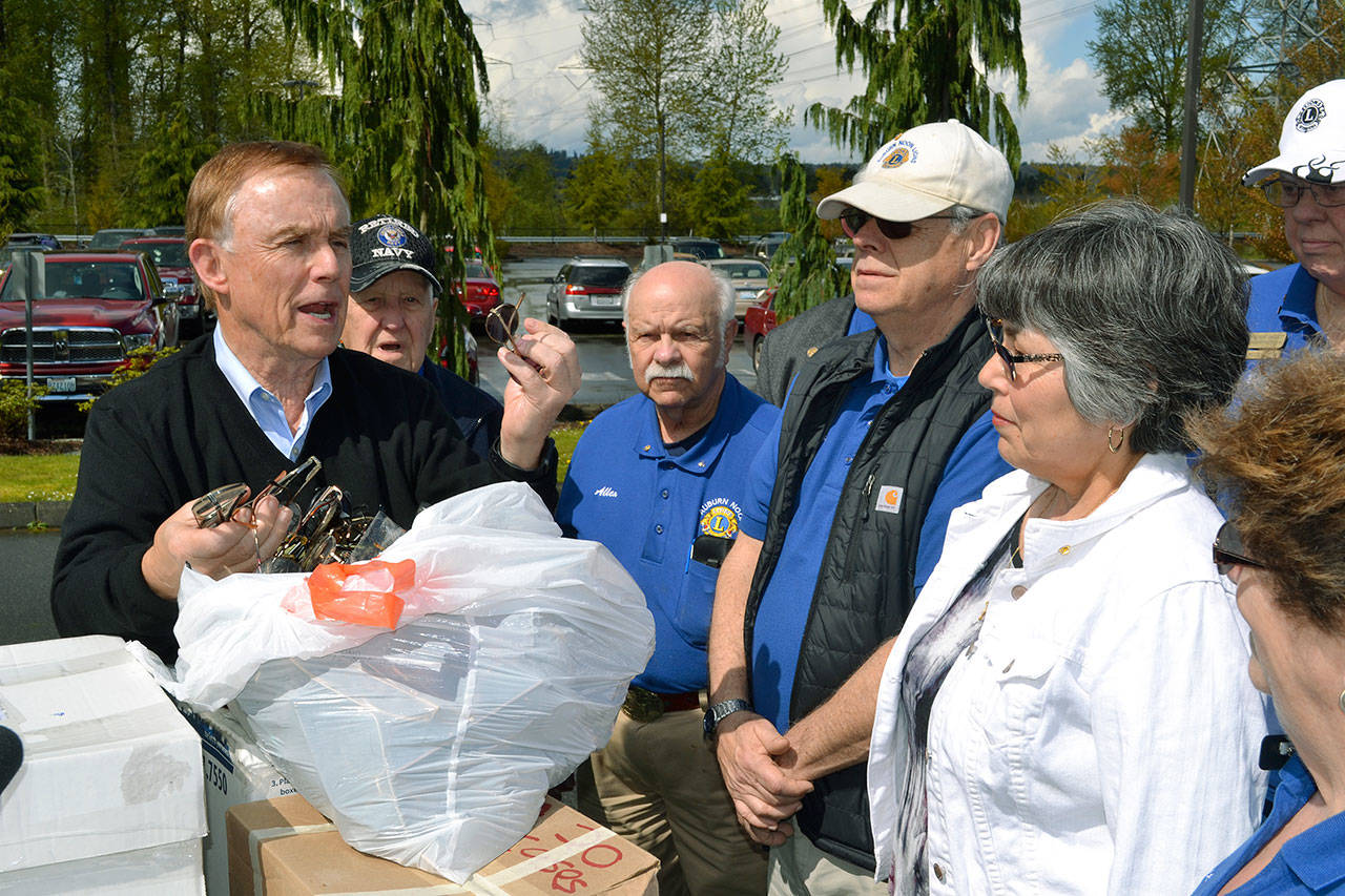 Sight for others: King County Councilmember Pete von Reichbauer holds some of the glasses being donated to the Lions Eyeglass Recycling Center program. ROBERT WHALE, Auburn Reporter
